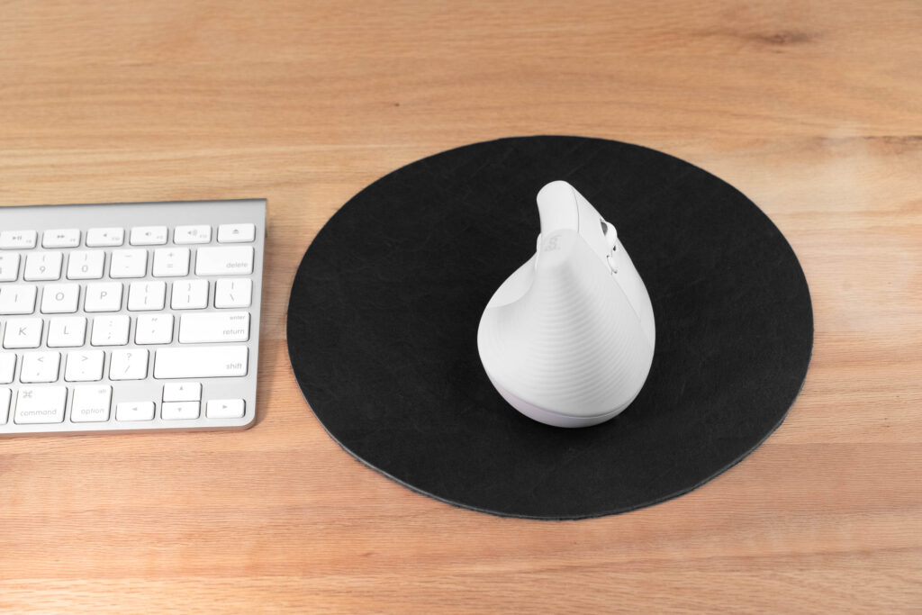 Black Round Leather Mouse Pad Next To Apple Keyboard Black Round Leather Mouse Pad Next To Apple Keyboard